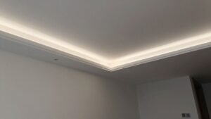 Modern Bangkok living room with a smooth, white stretch ceiling.